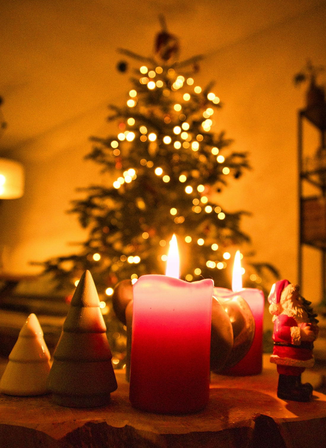 three pink pillar candles with gold and white christmas tree
