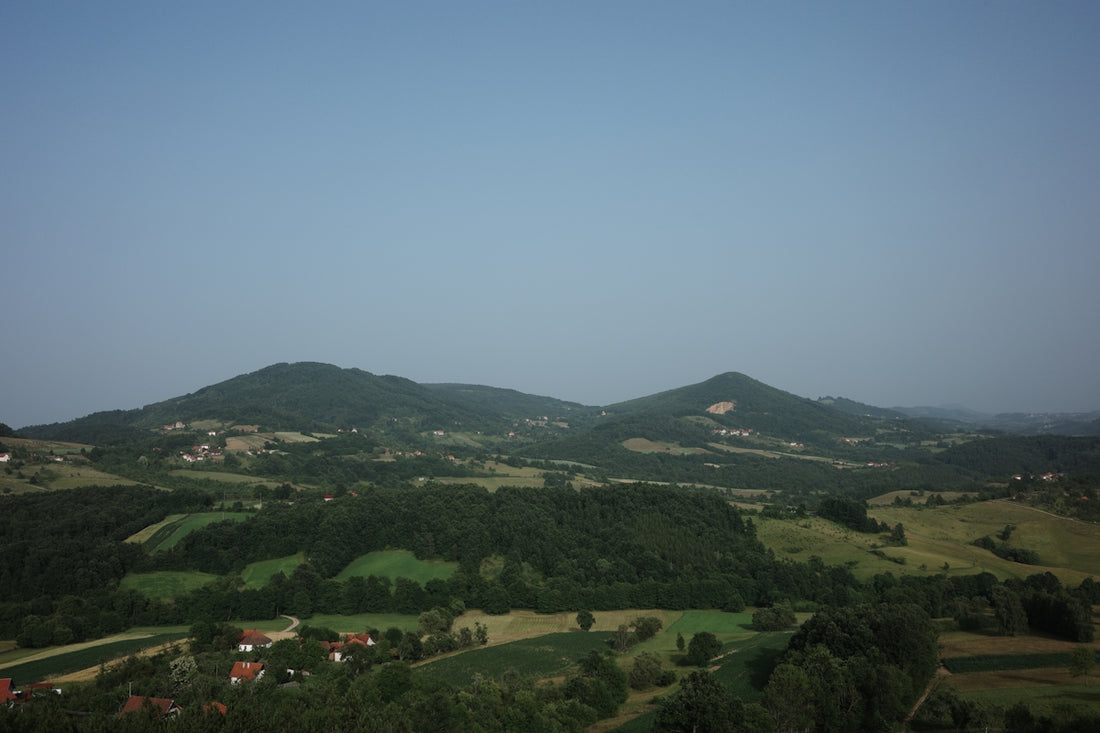 A view of a valley with a few hills in the distance