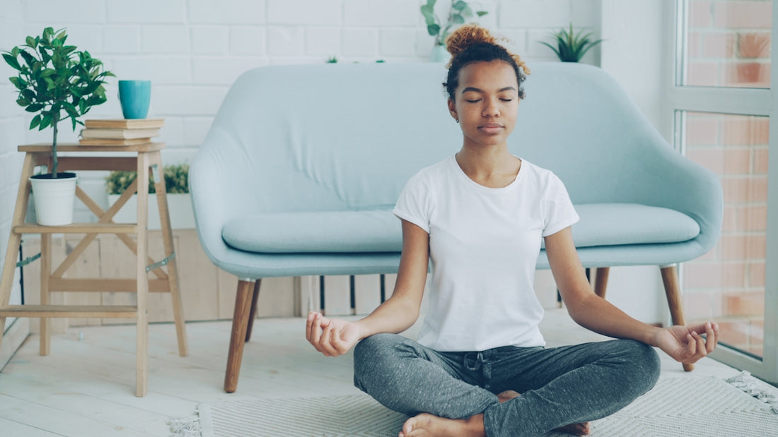 Young woman meditating on the floor at home.