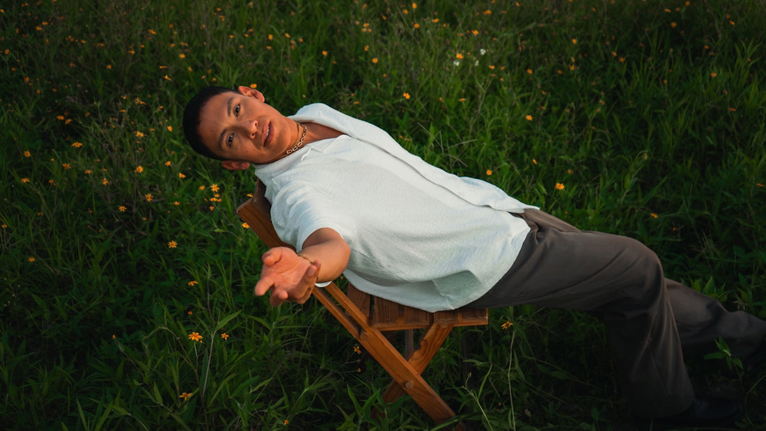 Man relaxing on chair in a grassy field.